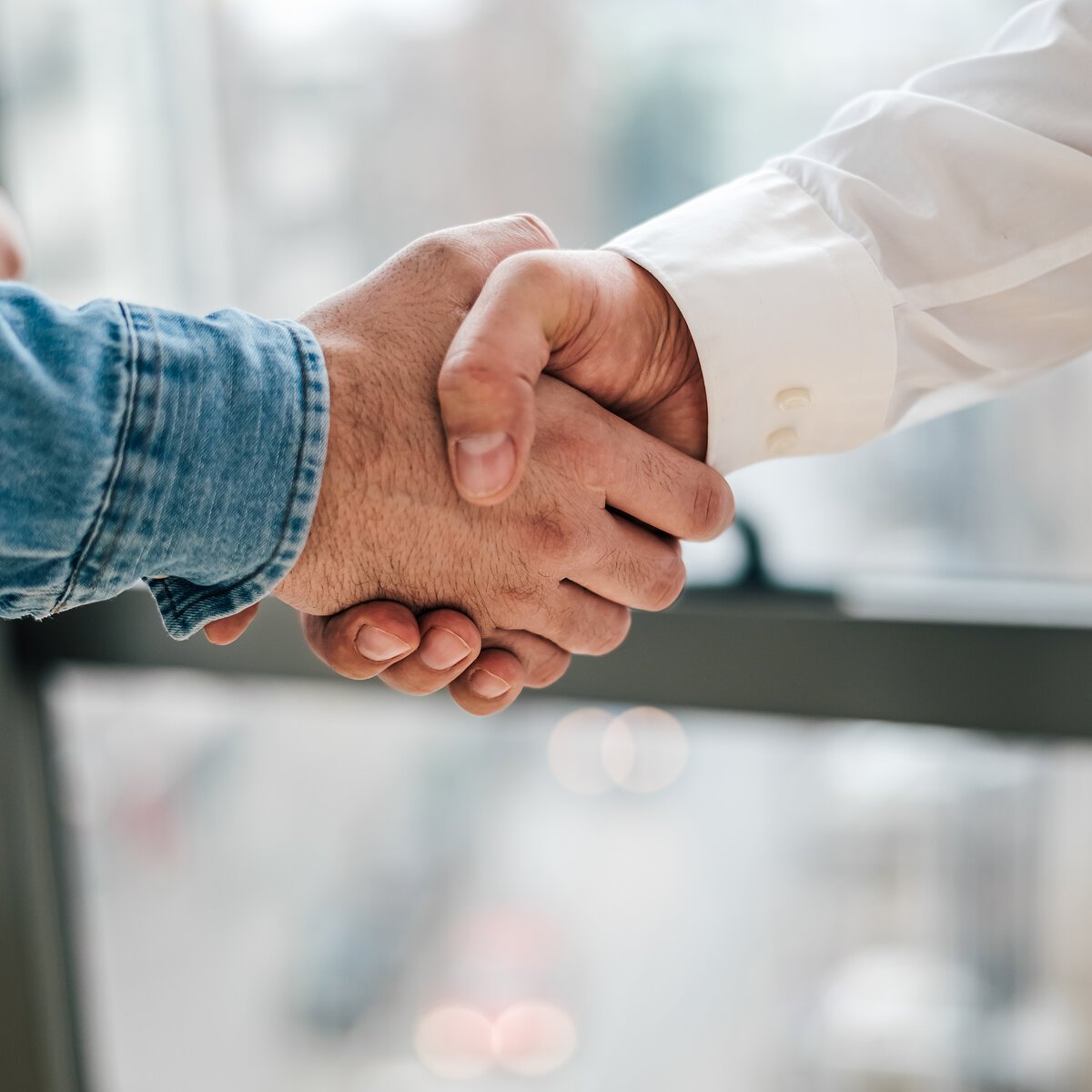 Close up shot of teamwork handshake in the office businessman en