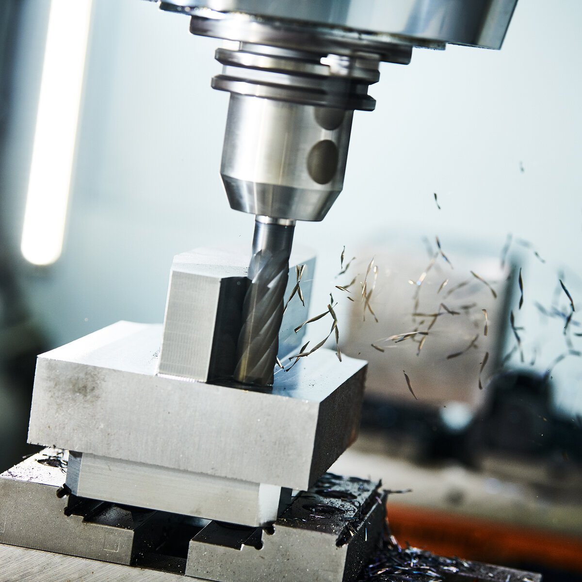 milling cnc machine at work. Metalworking multitool industry. Precision metal manufacturing. Shallow depth of view on shavings