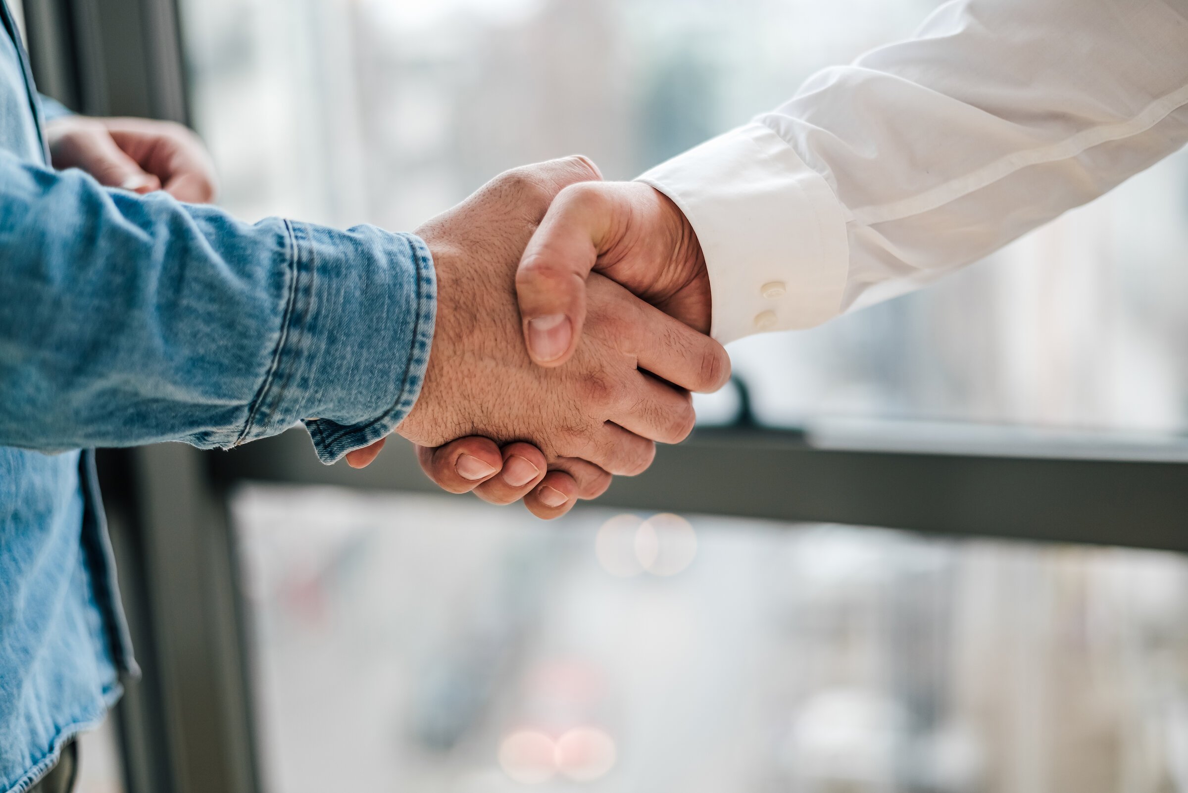 Close up shot of teamwork handshake in the office businessman en