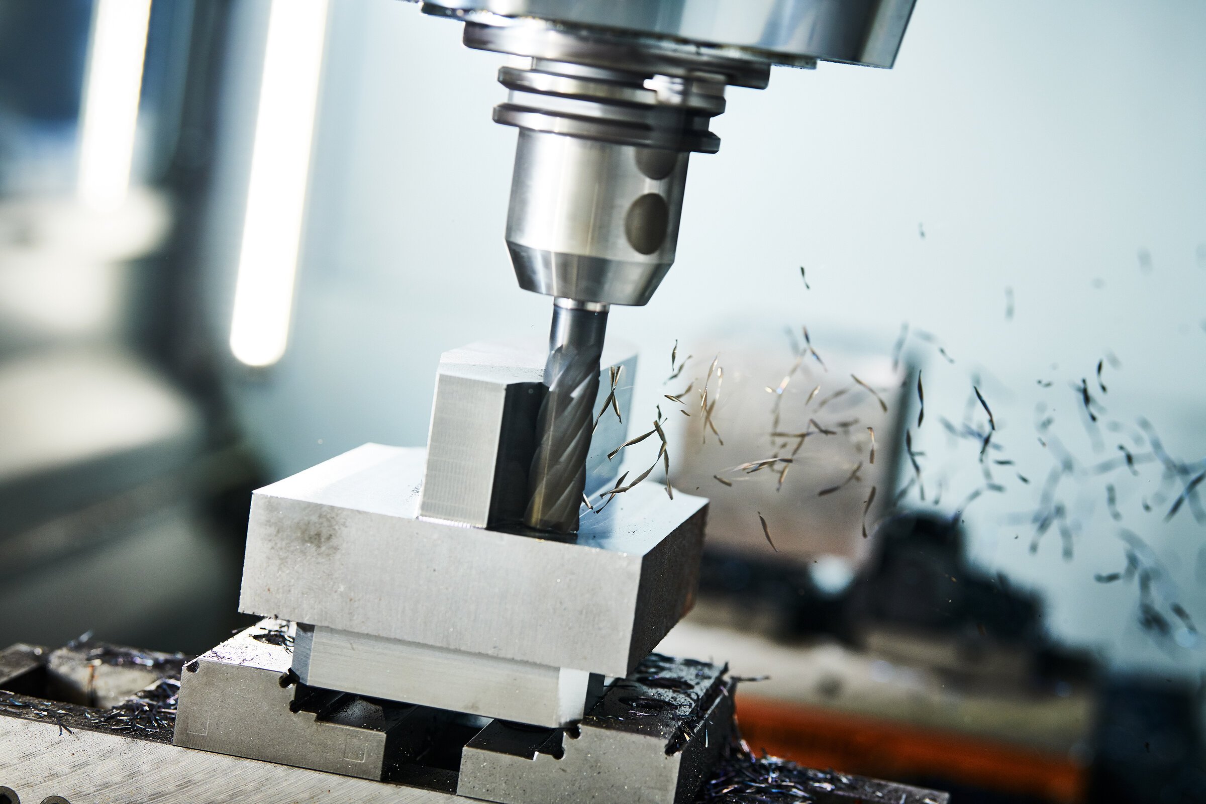 milling cnc machine at work. Metalworking multitool industry. Precision metal manufacturing. Shallow depth of view on shavings